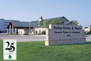Exterior view of Nalley-Pickle & Welch Funeral Home & Crematory with a large stone sign reading the name and address 3800, surrounded by a manicured lawn.