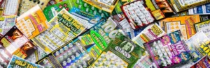 Close-up of a colorful pile of lottery scratch-off tickets scattered across a surface.